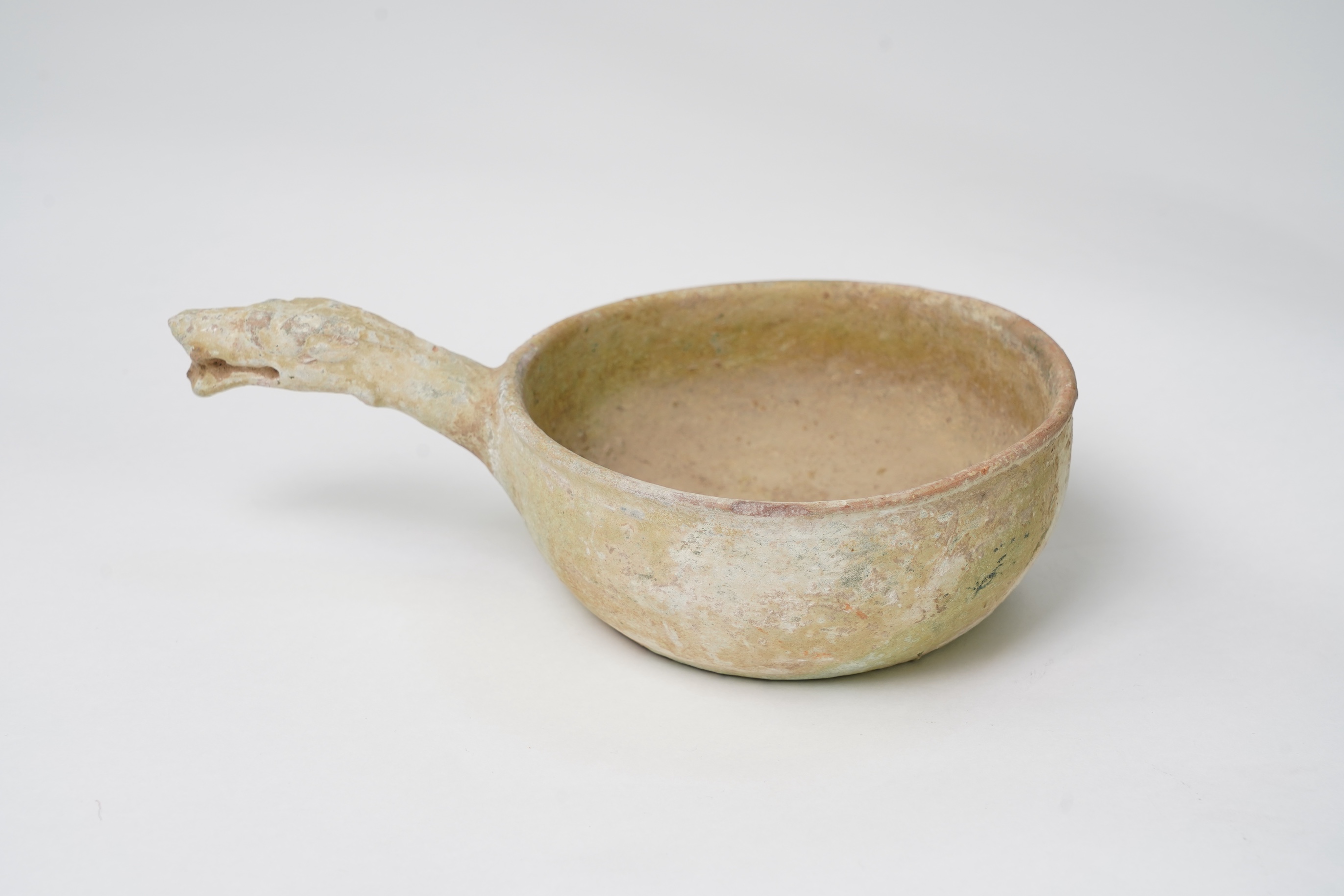 A Chinese earthenware scoop and a similar ladle, Han Dynasty (1st-2nd century A.D.)